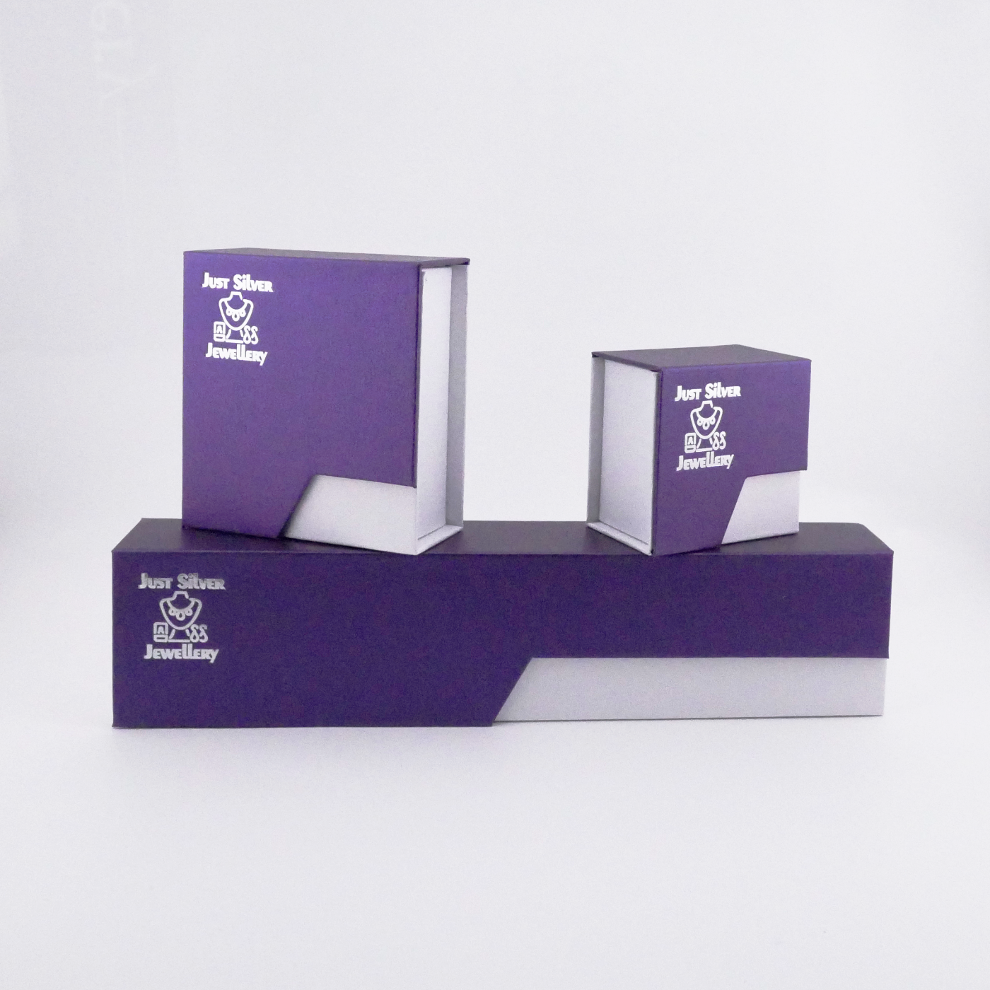 Set of purple jewelry boxes with a brand logo on a white background