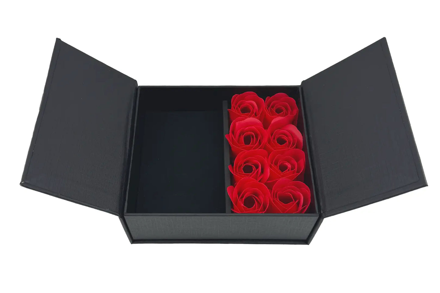 A red jewellery box with eight rose petals inside, accompanied by a matching red presentation bag with a rope handle.