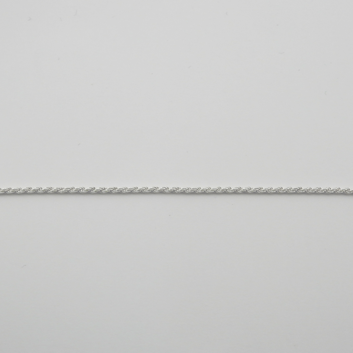 Silver chain on a light gray background