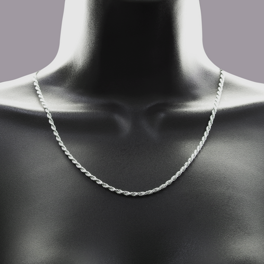 Silver chain necklace on a mannequin neck against a gray background