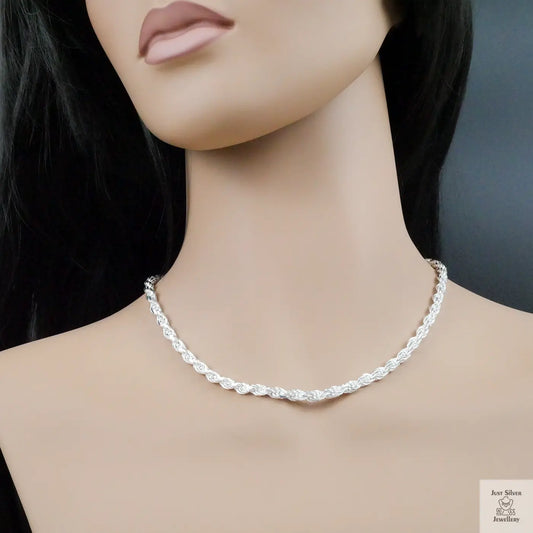 Silver necklace on a mannequin with a plain background