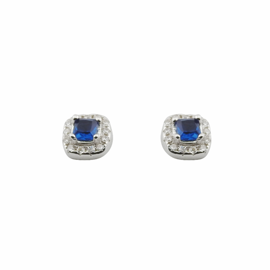 Pair of earrings with blue gemstones and clear stones on a white background