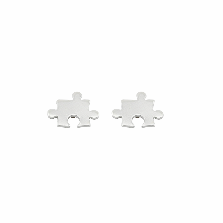 Two silver puzzle piece earrings on a white background