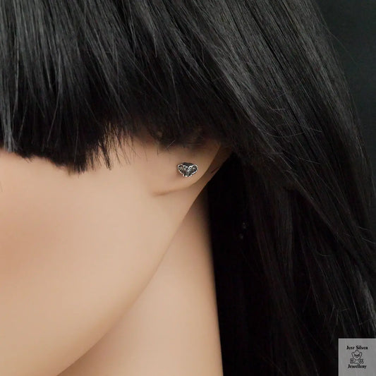 Elephant head shaped earring on a mannequin with black hair