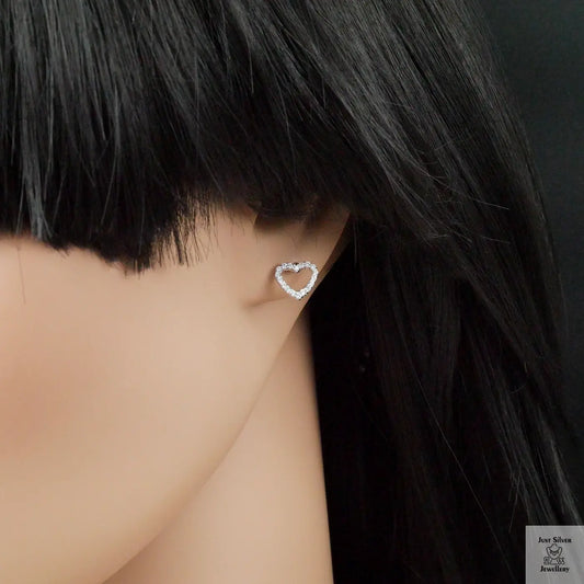 Heart-shaped earring worn by a person with black hair