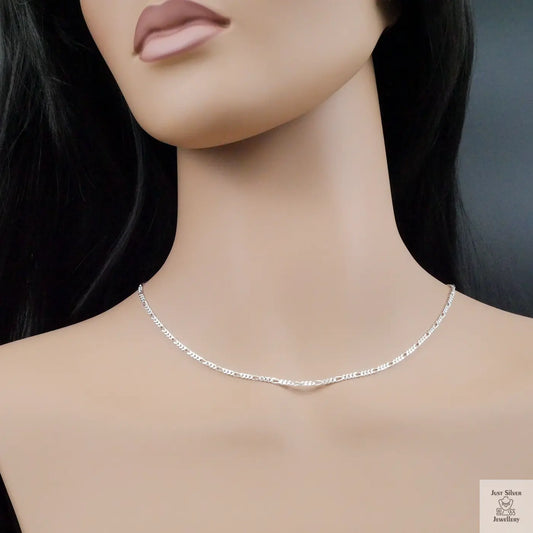 Mannequin wearing a silver necklace against a neutral background
