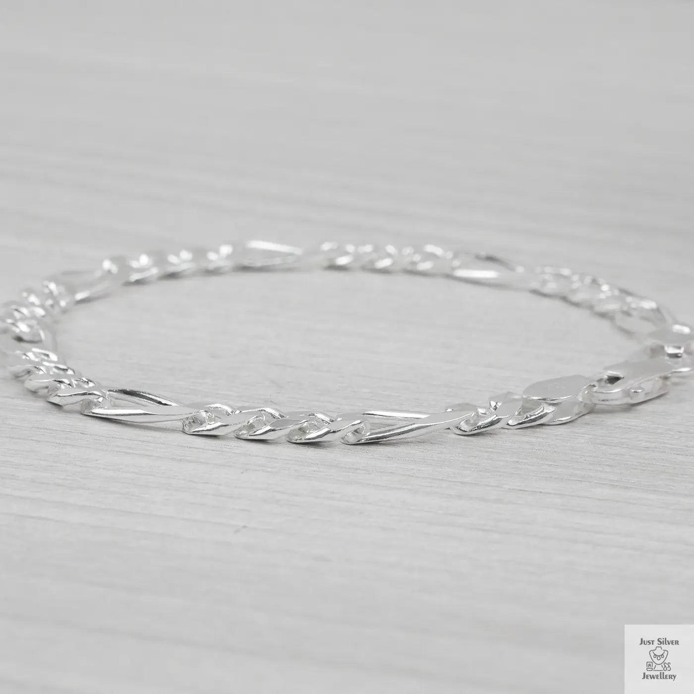 Silver bracelet on a light grey background
