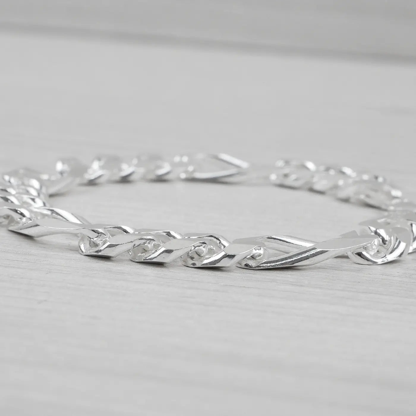 Silver bracelet on a light grey background