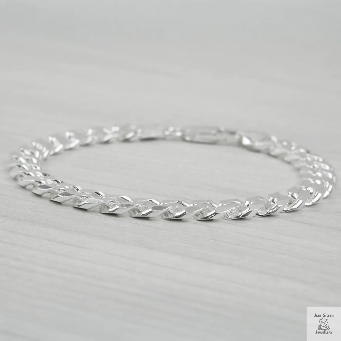 Silver bracelet on a light grey background