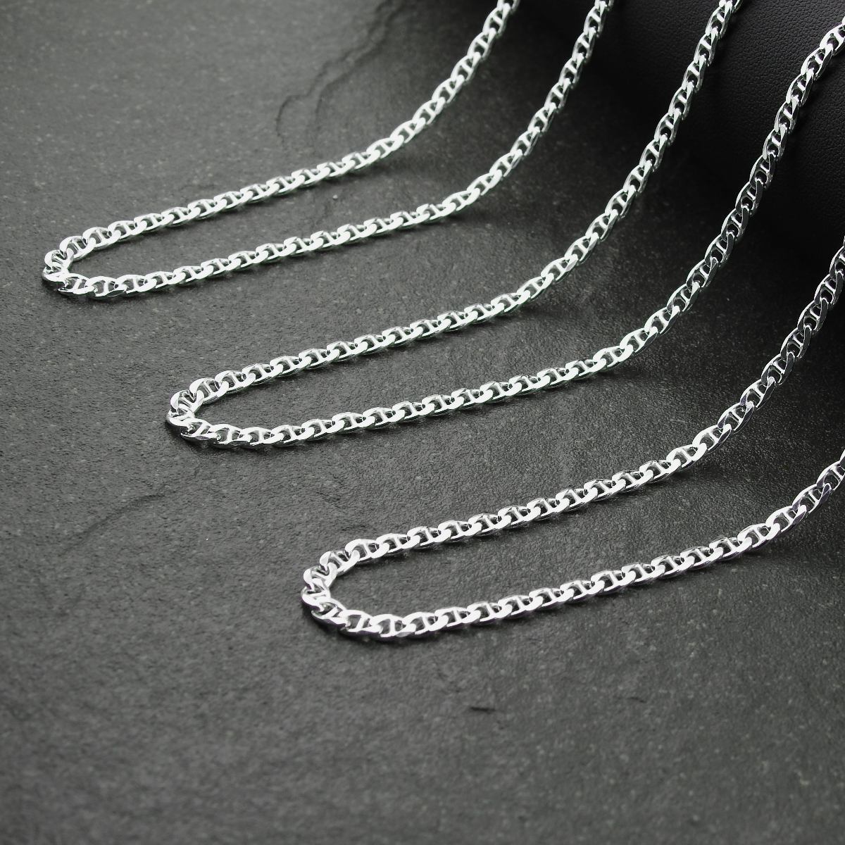 Silver chain on a dark gray background