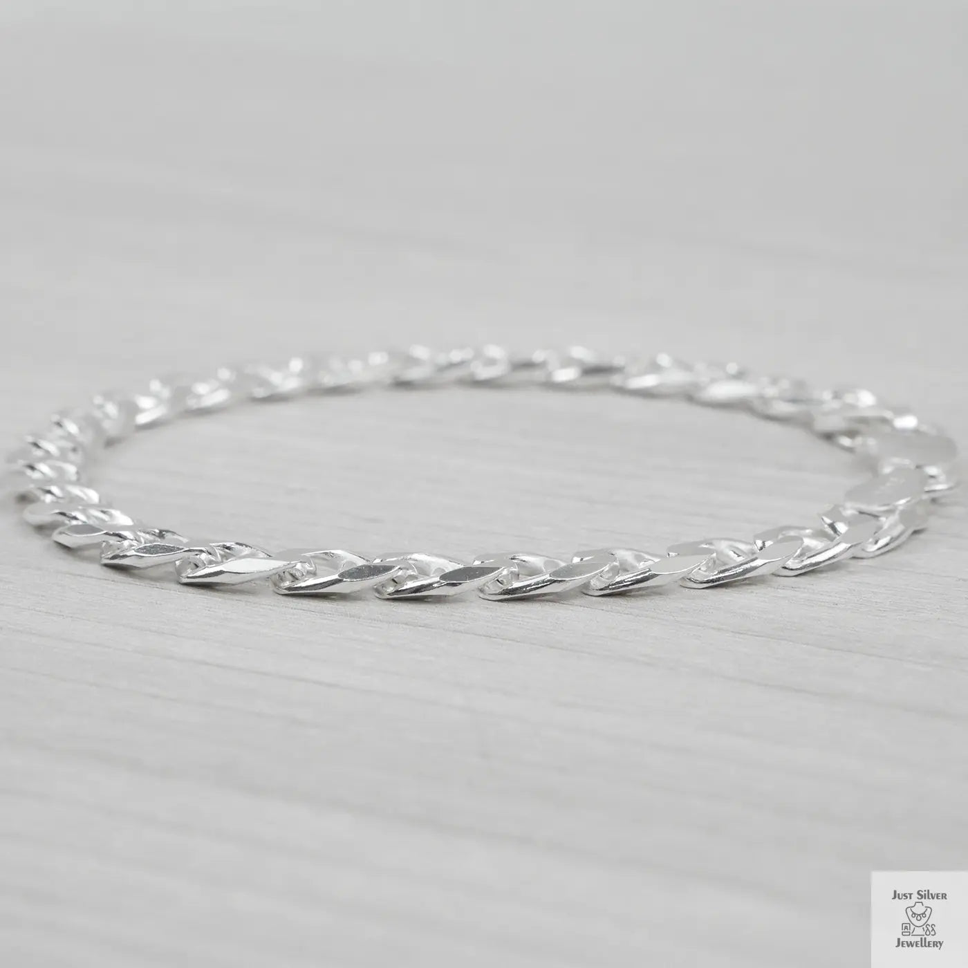 Silver bracelet on a light grey background