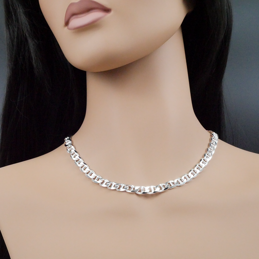 Silver chain necklace on a mannequin with a plain background