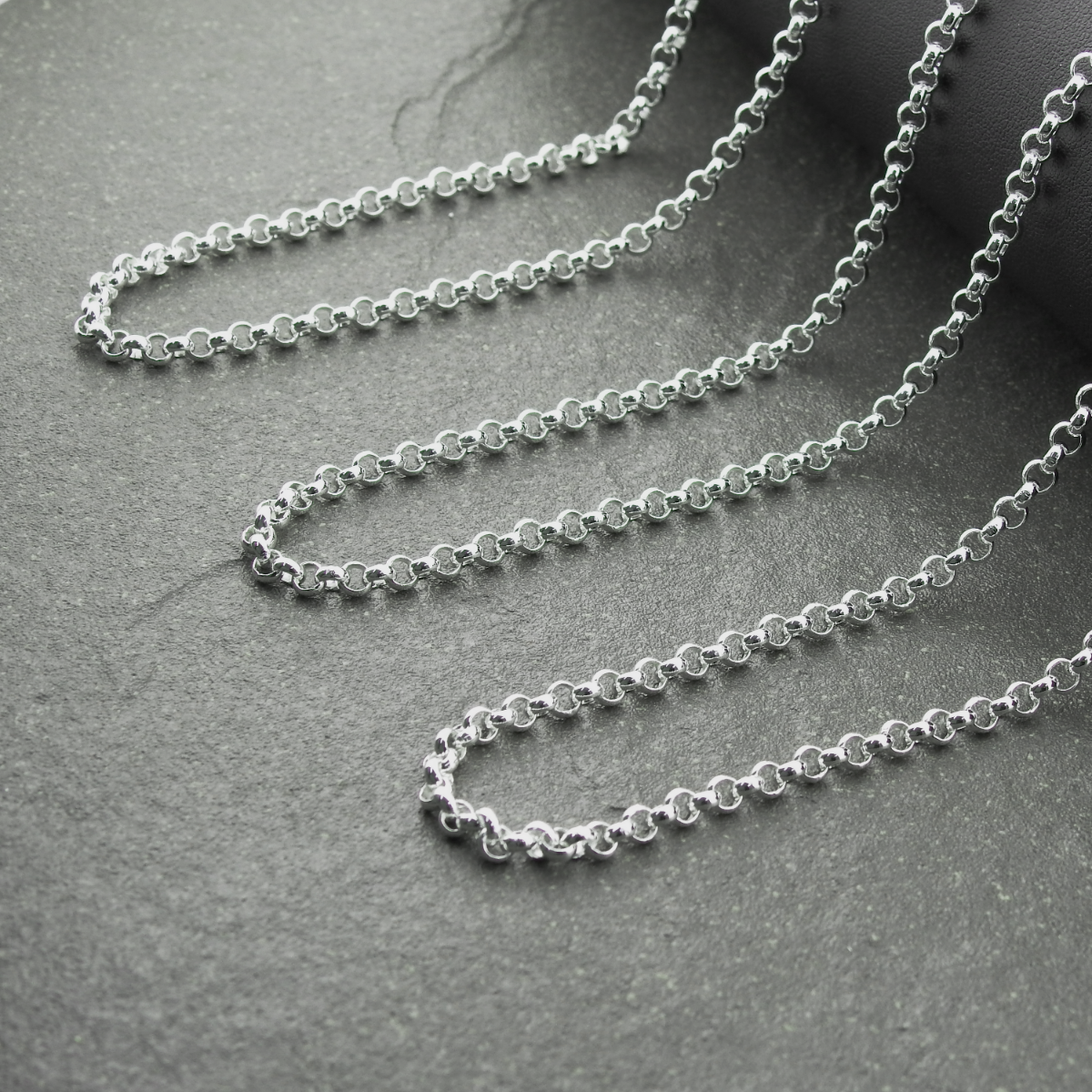 Silver chain on a gray surface