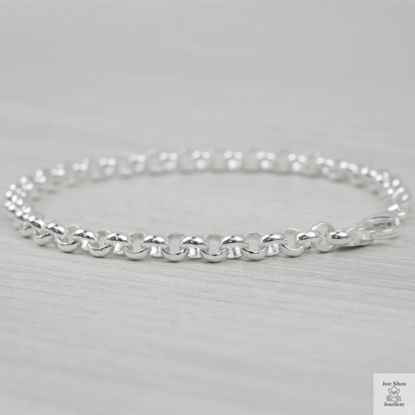 Silver bracelet on a light grey background
