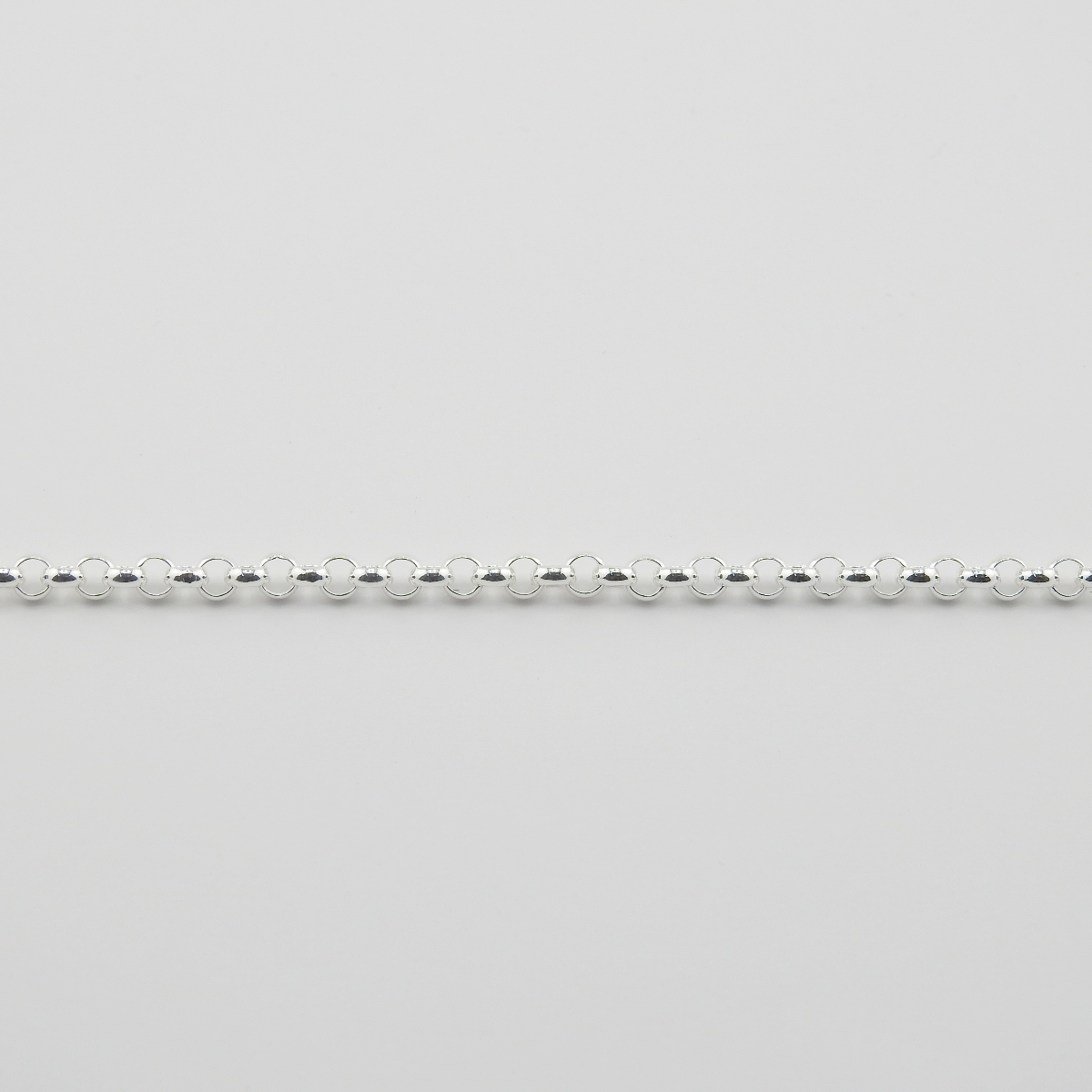 Silver beaded chain on a light gray background
