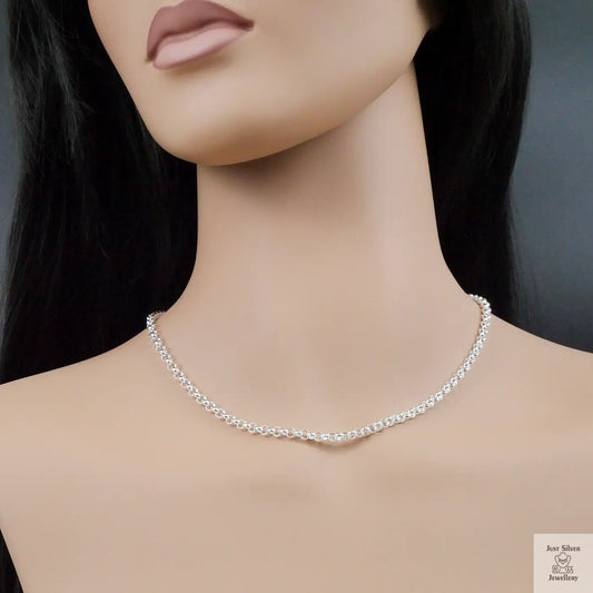 Silver necklace on a mannequin with a plain background