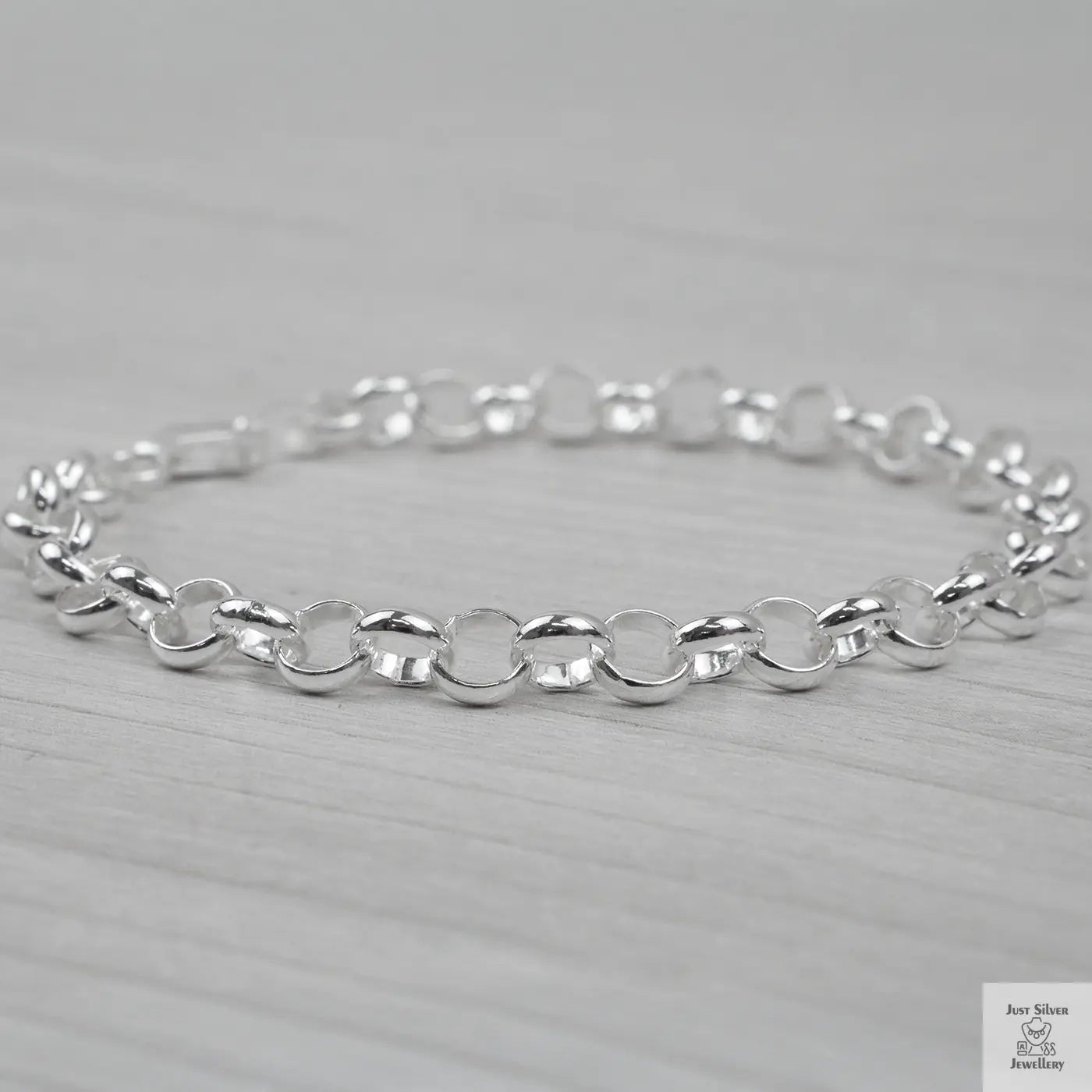 Silver bracelet on a light grey background