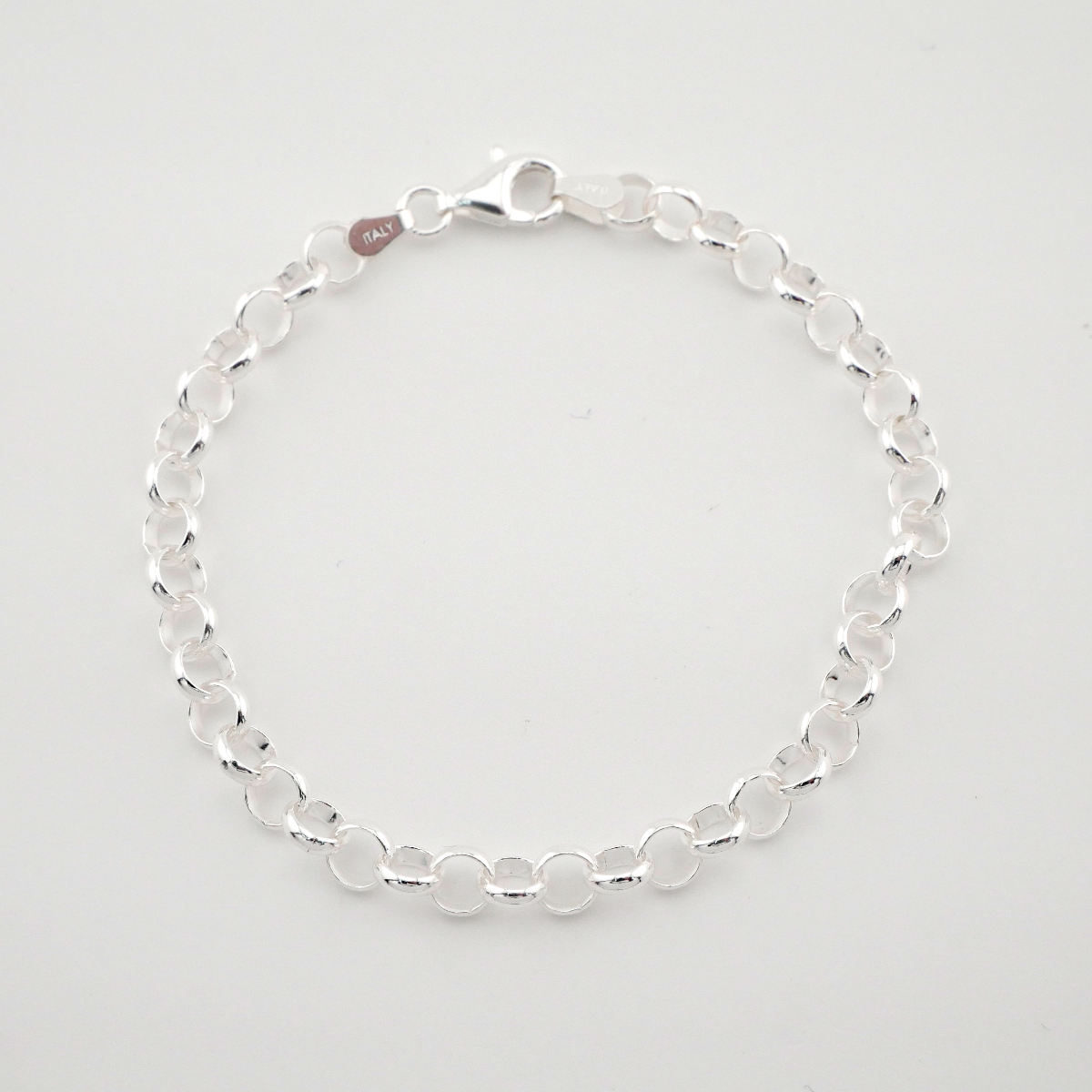 Silver bracelet on a light gray background