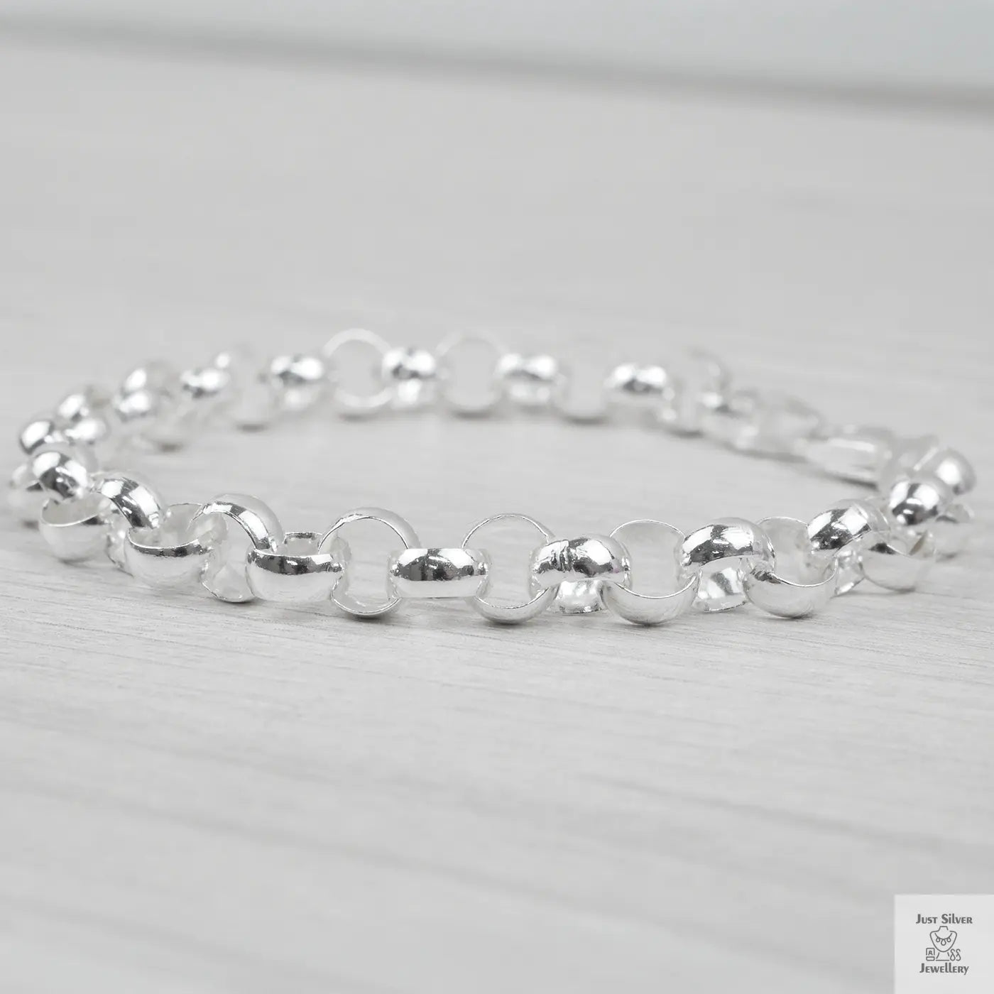 Silver bracelet on a light grey background