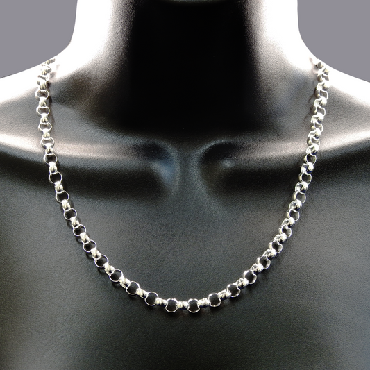 Silver chain necklace on a mannequin neck against a dark background