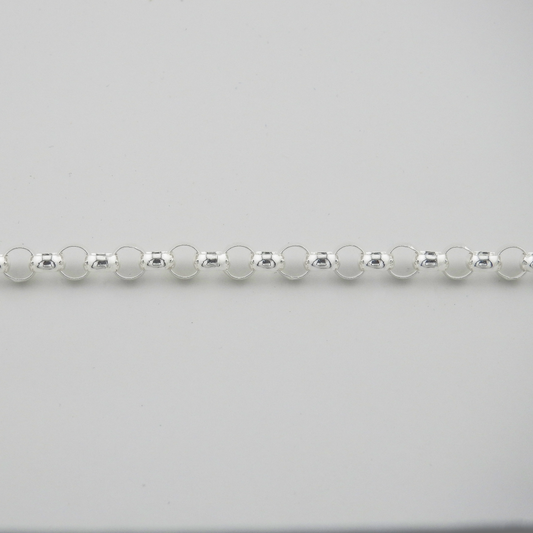 Close-up of a silver beaded necklace on a light gray background