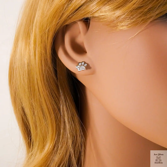 Paw print earring worn on a mannequin with blonde hair