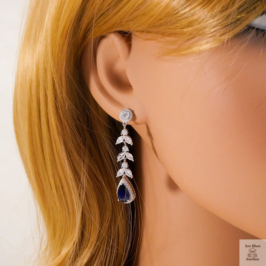 Earring worn on a mannequin with blonde hair against a white background