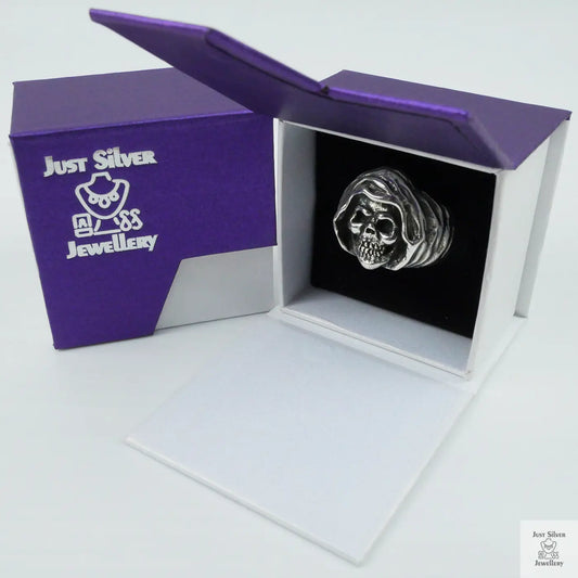 Silver skull ring in a 'Just Silver Jewellery' box on a white background