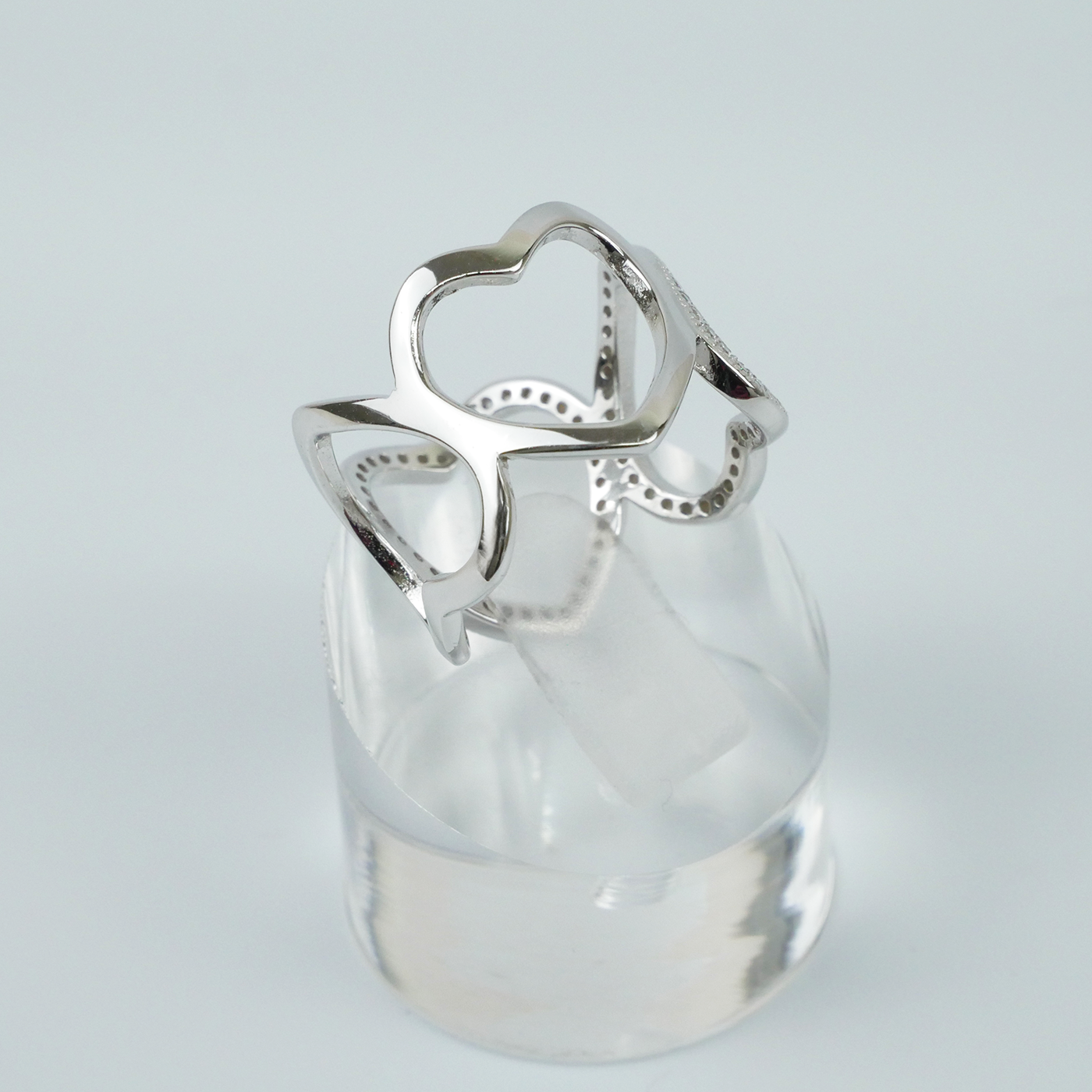 Silver ring with a unique design on a light gray background