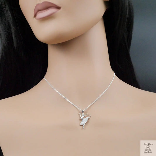 Silver necklace with a pendant on a mannequin against a dark background