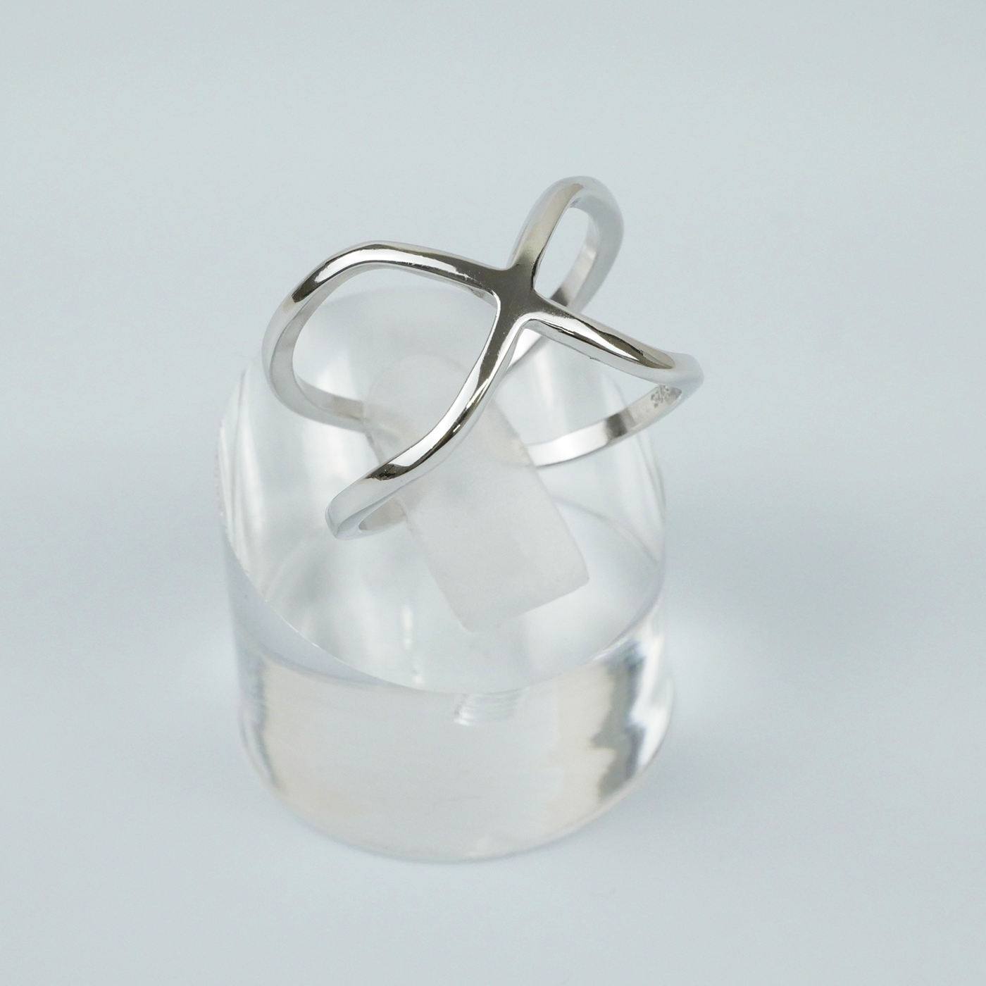 Silver ring with a unique design on a light grey background