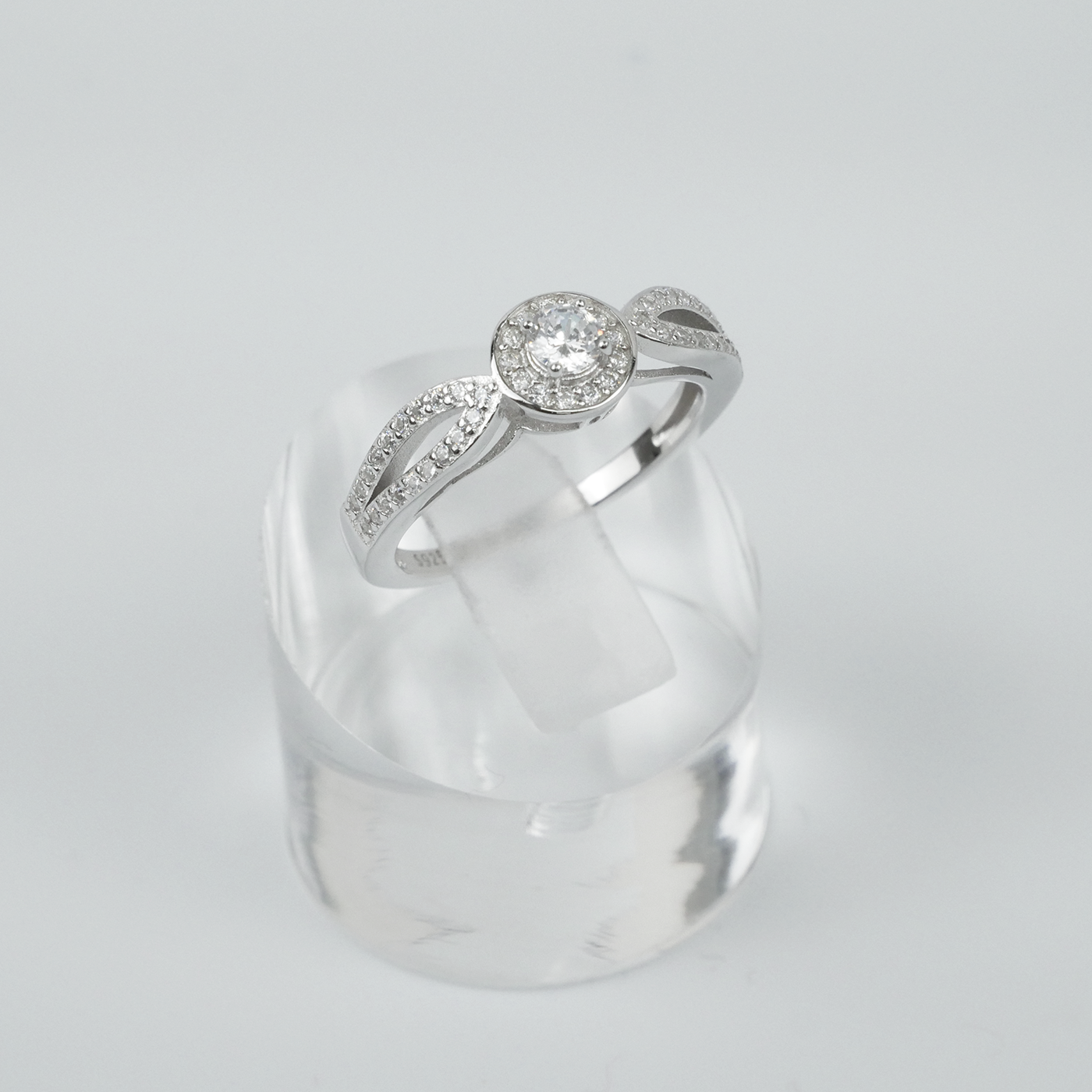 Silver ring with gemstones on a light grey background