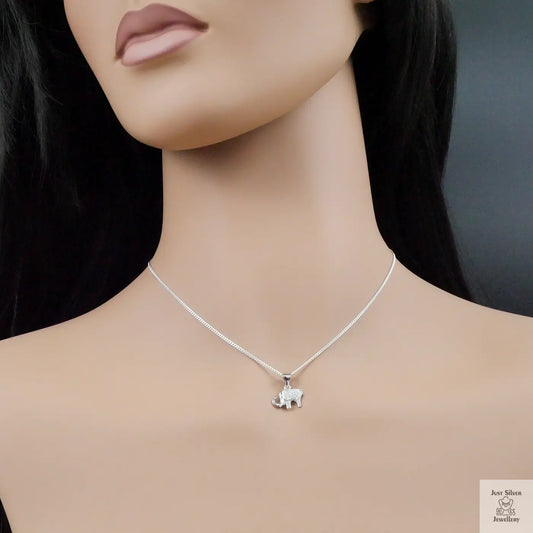Necklace with a small elephant pendant on a mannequin with a dark background