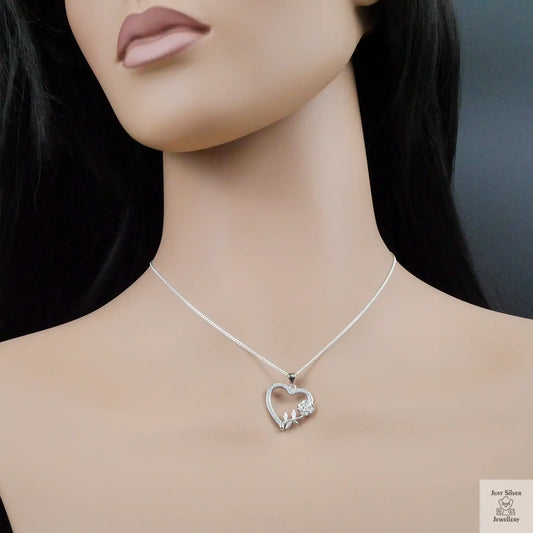 Silver necklace with a heart-shaped pendant on a mannequin