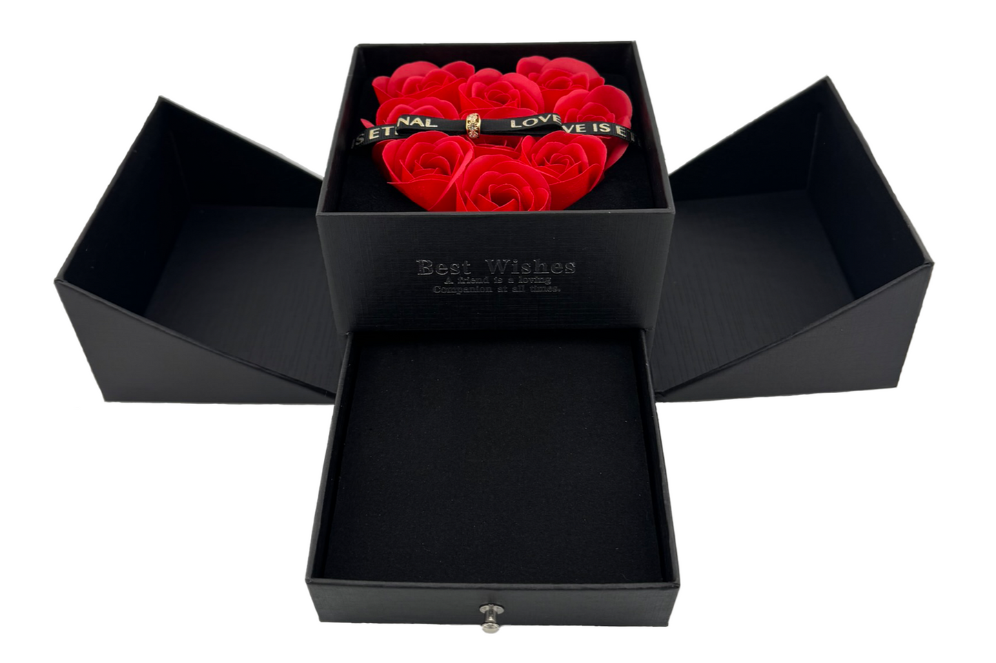 A red jewellery box with a heart-shaped arrangement of red roses on the lid, secured with a magnetic bow. The box is open, revealing cutouts for holding jewelry items like chains, earrings, and rings.