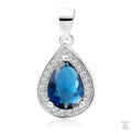 A silver teardrop-shaped pendant with a central blue sapphire gemstone surrounded by white zirconia