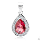 A silver pendant with a teardrop-shaped central ruby gemstone surrounded by white zirconia