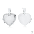 A two-sided silver locket with a heart shape and white zirconia embellishments on the front.