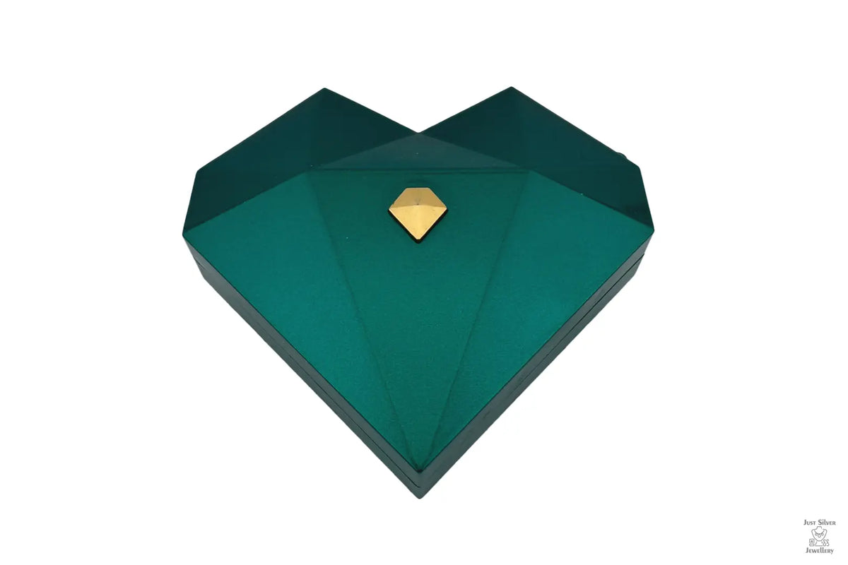 Three heart-shaped ring gift boxes in white, green, and red, with gold accents, displayed in an open presentation box.