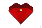 Three heart-shaped ring gift boxes in white, green, and red, with gold accents, displayed in an open presentation box.