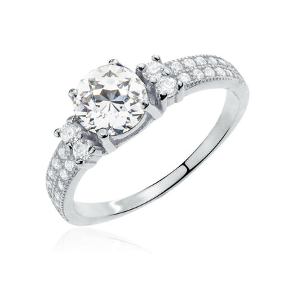 Silver ring with a large central diamond and smaller diamonds on the sides against a white background
