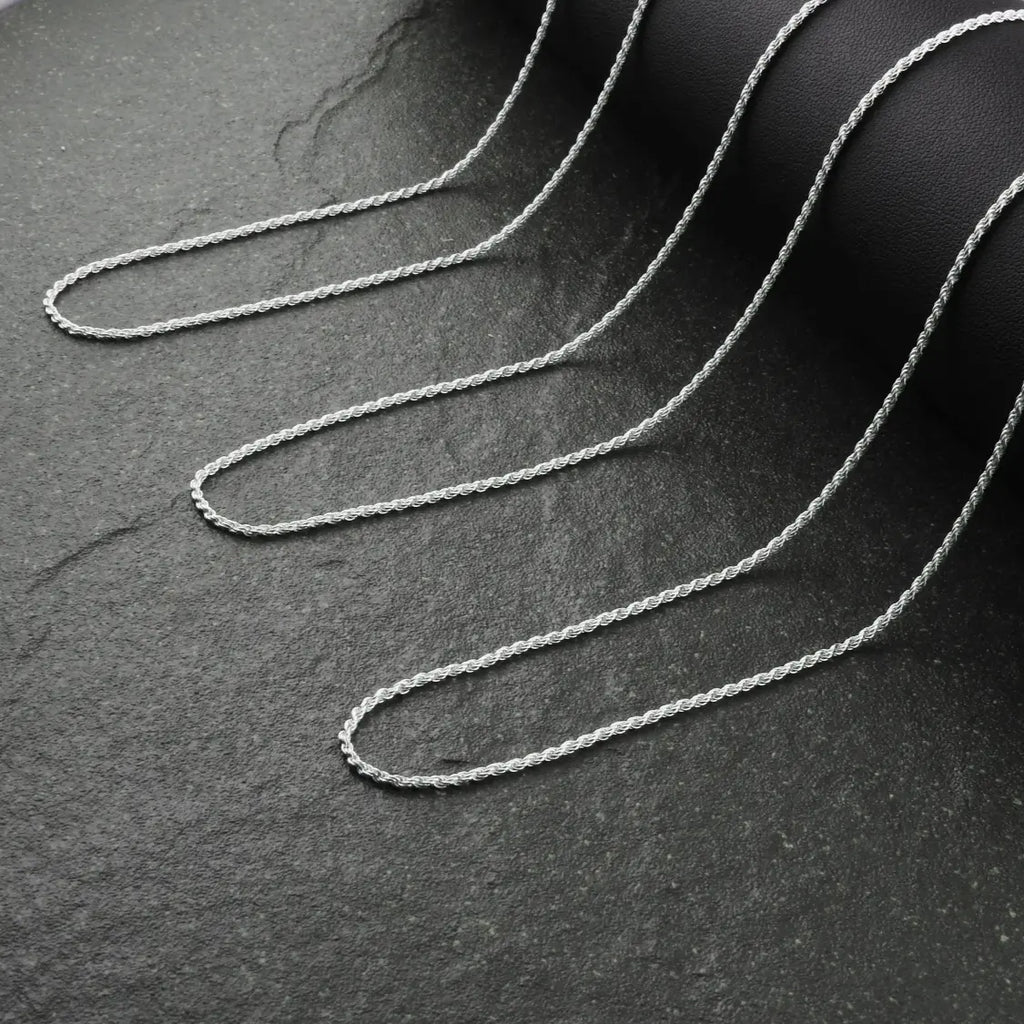 Silver chain on a dark textured surface