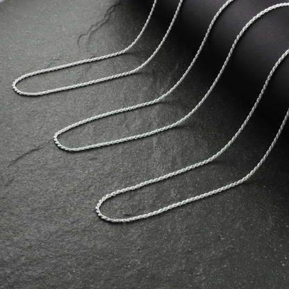 Silver chain on a dark textured surface