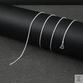 Silver rope chain necklace on a black background