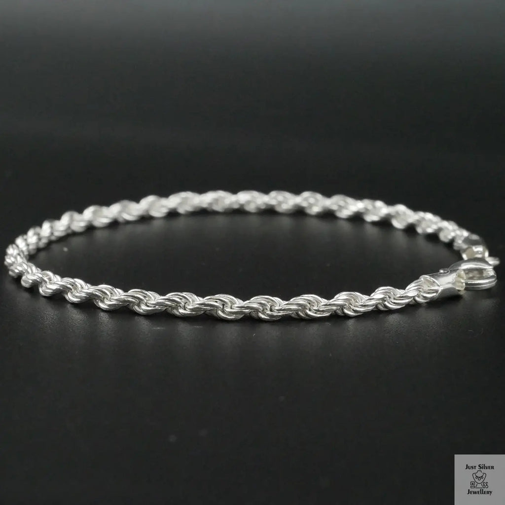 Silver rope bracelet on a black background