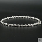 Silver rope bracelet on a black background