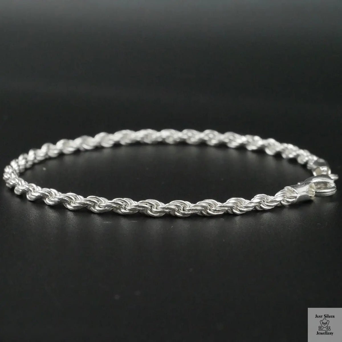 Silver rope bracelet on a black background