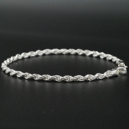 Silver rope bracelet on a black background