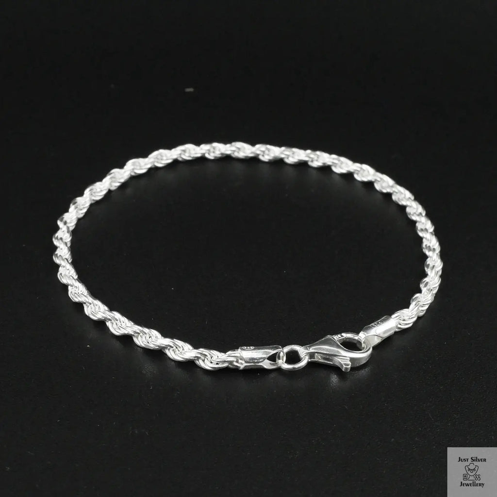Silver rope bracelet on a black background
