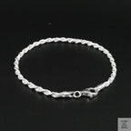Silver rope bracelet on a black background